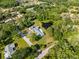 Aerial view of the neighborhood showing a private lake and lush green landscaping at 2400 Commack Ct, New Port Richey, FL 34655