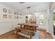 Dining area showcases a rustic wood table, shiplap accent wall, and modern chandelier at 2400 Commack Ct, New Port Richey, FL 34655