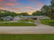 Beautiful home exterior featuring lush landscaping, a well-manicured lawn, and an inviting driveway at 2400 Commack Ct, New Port Richey, FL 34655