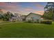 Lush front lawn and landscaping surrounding the charming single-story home at 2400 Commack Ct, New Port Richey, FL 34655