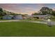 Expansive single-story home with lush lawn, circular driveway, and a three-car garage at 2400 Commack Ct, New Port Richey, FL 34655