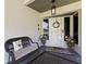 Inviting front porch with a decorative wreath, bench, and potted plants at 2400 Commack Ct, New Port Richey, FL 34655
