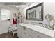 Stylish guest house bathroom with marble countertop vanity, framed mirror, and modern fixtures at 2400 Commack Ct, New Port Richey, FL 34655
