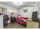 Cozy guest house bedroom featuring hardwood floors, a window, and comfortable furnishings at 2400 Commack Ct, New Port Richey, FL 34655