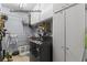 Modern guest house laundry room with a black washing machine and ample cabinet storage at 2400 Commack Ct, New Port Richey, FL 34655