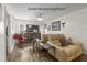 Comfortable guest house living room with hardwood floors, cozy seating, and a large television at 2400 Commack Ct, New Port Richey, FL 34655