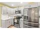 Bright kitchen boasts stainless steel appliances, stone countertops and stylish gray cabinetry at 2400 Commack Ct, New Port Richey, FL 34655