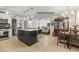 Spacious open-concept living room featuring tile floors and natural lighting, with dining area at 2400 Commack Ct, New Port Richey, FL 34655