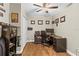 Well-lit office space with dark wood flooring, neutral walls, and a ceiling fan at 2400 Commack Ct, New Port Richey, FL 34655