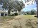 Spacious property featuring buildings with mature trees and blue skies at 2400 Commack Ct, New Port Richey, FL 34655