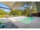 Sparkling pool surrounded by lush landscaping and a relaxing patio area at 2400 Commack Ct, New Port Richey, FL 34655