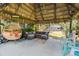 Tiki hut with outdoor seating and lush greenery in backyard at 2400 Commack Ct, New Port Richey, FL 34655