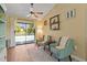 Cozy sitting area with two armchairs overlooking the backyard pool through sliding glass doors at 2400 Commack Ct, New Port Richey, FL 34655