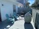 Cozy back deck featuring two chairs and a grill, perfect for outdoor relaxation and entertaining at 2729 Penzance St, Palm Harbor, FL 34684