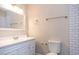 Bathroom with a vanity, toilet, and tiled shower at 2729 Penzance St, Palm Harbor, FL 34684