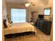 Bedroom with a neutral palette, ceiling fan, wood-look flooring, and a large window at 2729 Penzance St, Palm Harbor, FL 34684