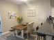 Bright dining area featuring a wood table, bench and chairs next to the kitchen and breakfast bar at 2729 Penzance St, Palm Harbor, FL 34684