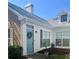 Charming home exterior showcasing a quaint blue front door with wreath and well-maintained landscaping at 2729 Penzance St, Palm Harbor, FL 34684