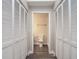 Hallway with storage closet leading to a bathroom with subway tile at 2729 Penzance St, Palm Harbor, FL 34684