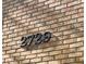Close-up of the house number '2729' in dark numerals mounted on a brick wall at 2729 Penzance St, Palm Harbor, FL 34684