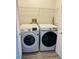Modern laundry room with white washer and dryer, offering convenience at 2729 Penzance St, Palm Harbor, FL 34684