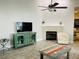Spacious living room with vaulted ceilings, fan, fireplace, and decorative furniture at 2729 Penzance St, Palm Harbor, FL 34684