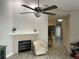 Living room with fireplace, ceiling fan, and wood-look flooring at 2729 Penzance St, Palm Harbor, FL 34684