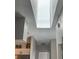 Bright hallway featuring a large skylight that brings in natural light and illuminates the interior at 2729 Penzance St, Palm Harbor, FL 34684