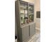 A gray display cabinet featuring glass doors and sliding lower doors at 2729 Penzance St, Palm Harbor, FL 34684