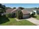 Charming single-story home featuring a two-car garage, well-manicured lawn, and mature landscaping at 3054 Oakbrook Cir, Clearwater, FL 33759