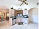 Well-lit kitchen with vaulted ceiling, stainless steel appliances, and tiled flooring at 3054 Oakbrook Cir, Clearwater, FL 33759