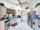 Well-lit kitchen with vaulted ceiling, stainless steel appliances, and tiled flooring at 3054 Oakbrook Cir, Clearwater, FL 33759