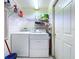 Efficient laundry room equipped with a washer, dryer, and storage shelves, providing convenience for laundry needs at 3054 Oakbrook Cir, Clearwater, FL 33759
