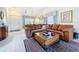 Spacious living area with comfortable leather sofa, vaulted ceiling, and tile flooring at 3054 Oakbrook Cir, Clearwater, FL 33759