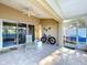 Enclosed tiled patio with ceiling fan provides ample space for relaxation or entertaining guests at 3054 Oakbrook Cir, Clearwater, FL 33759