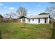 Backyard with a white exterior, concrete patio, and fenced in yard at 3141 Loomis Dr, New Port Richey, FL 34655