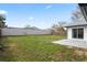Backyard with a white fence, a concrete patio, and grass at 3141 Loomis Dr, New Port Richey, FL 34655