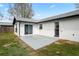 Backyard with a concrete patio, grass, and a white exterior wall at 3141 Loomis Dr, New Port Richey, FL 34655