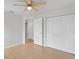 Bedroom with wooden floors, ceiling fan, and closet with doors at 3141 Loomis Dr, New Port Richey, FL 34655