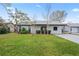 Charming single-story home boasts a well-maintained lawn and updated exterior paint at 3141 Loomis Dr, New Port Richey, FL 34655