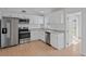 Updated kitchen with white cabinets, granite countertops, stainless steel appliances, and subway tile backsplash at 3141 Loomis Dr, New Port Richey, FL 34655
