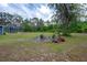Large backyard with fire pit, ample green space, and screened-in pool area for outdoor enjoyment at 3355 La Vista St, Brooksville, FL 34604