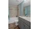 Well-lit bathroom featuring a shower-tub combo, sleek vanity, and modern fixtures at 3355 La Vista St, Brooksville, FL 34604