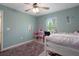 Bright bedroom with a window, a unique dollhouse, neutral decor, and comfortable furnishings at 3355 La Vista St, Brooksville, FL 34604