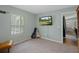 Inviting bedroom featuring a large window, wall-mounted TV, and tasteful decor at 3355 La Vista St, Brooksville, FL 34604