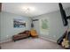 Comfortable bedroom featuring a daybed, a yellow chair, a ceiling fan, and stylish decor at 3355 La Vista St, Brooksville, FL 34604