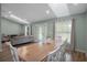Dining area with a large table, wood-look floors and lots of natural light from the doors and windows at 3355 La Vista St, Brooksville, FL 34604