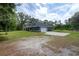Spacious single-story home with an attached garage, large driveway, and expansive green lawn at 3355 La Vista St, Brooksville, FL 34604
