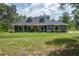 Charming single-story home featuring a covered front porch and well-maintained lawn and landscaped front yard at 3355 La Vista St, Brooksville, FL 34604