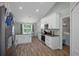 Modern kitchen features white cabinetry, updated appliances, stone counters, and adjacent dining area at 3355 La Vista St, Brooksville, FL 34604